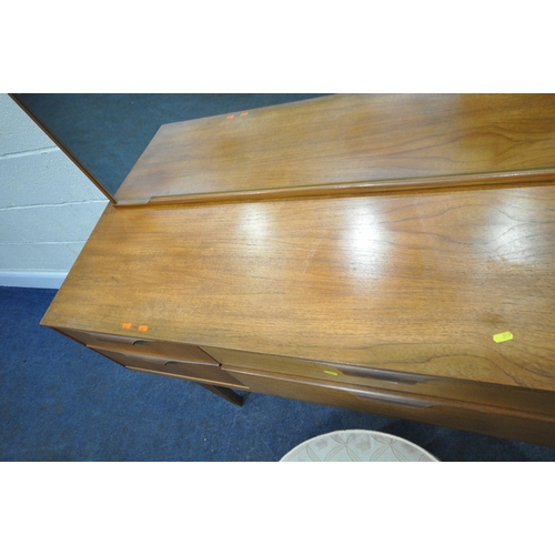 217 - AUSTINSUITE, A MID CENTURY TEAK DRESSING TABLE, with a rectangular mirror, six drawers, raised on ta... 