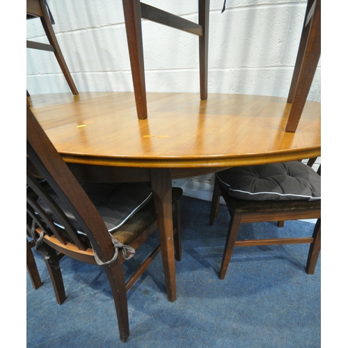 224 - WILLIAM LAWRENCE, A MID CENTURY TEAK OVAL EXTENDING DINING TABLE, with a single fold out leaf, raise... 