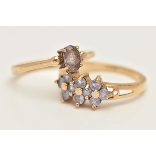 426 - TWO 9CT YELLOW GOLD GEM SET RINGS, to include a single stone iolite ring set with an oval shape mixe... 