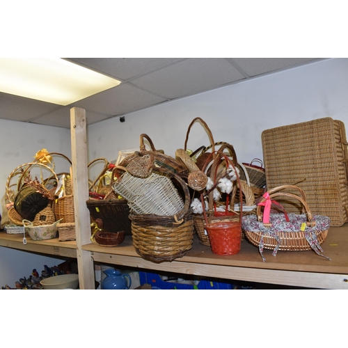 895 - A LARGE QUANTITY OF WICKER BASKETS comprising approximately thirty baskets in various forms and styl... 