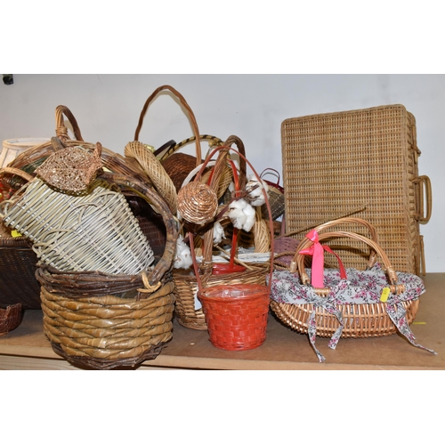 895 - A LARGE QUANTITY OF WICKER BASKETS comprising approximately thirty baskets in various forms and styl... 