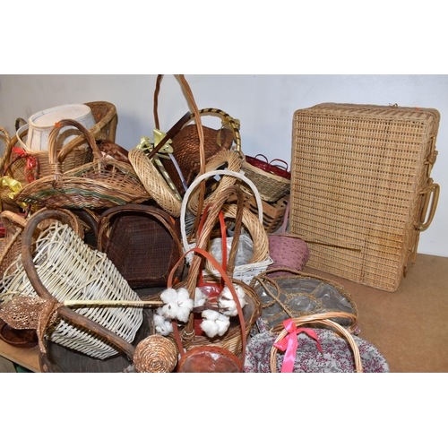 895 - A LARGE QUANTITY OF WICKER BASKETS comprising approximately thirty baskets in various forms and styl... 