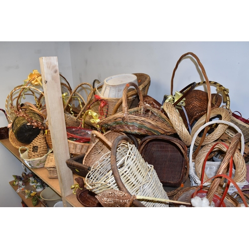 895 - A LARGE QUANTITY OF WICKER BASKETS comprising approximately thirty baskets in various forms and styl... 