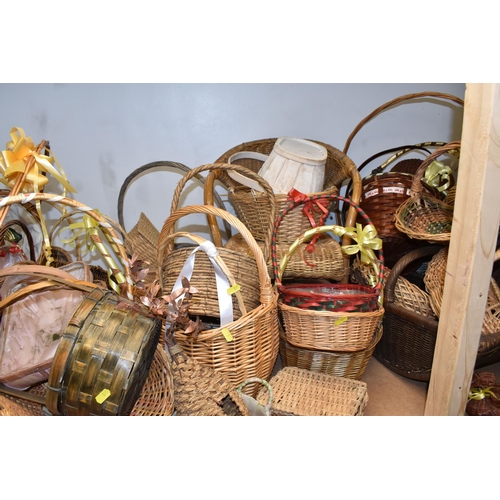 895 - A LARGE QUANTITY OF WICKER BASKETS comprising approximately thirty baskets in various forms and styl... 