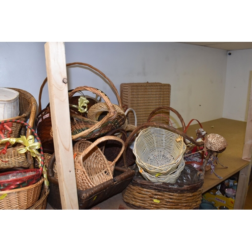 895 - A LARGE QUANTITY OF WICKER BASKETS comprising approximately thirty baskets in various forms and styl... 