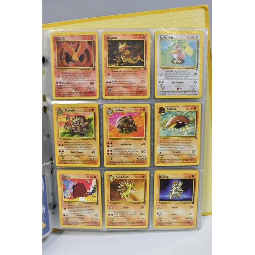 931 - A FOLDER OF POKEMON CARDS, includes cards from the Base Set, Base Set 2, Jungle, Fossil, Team Rocket... 