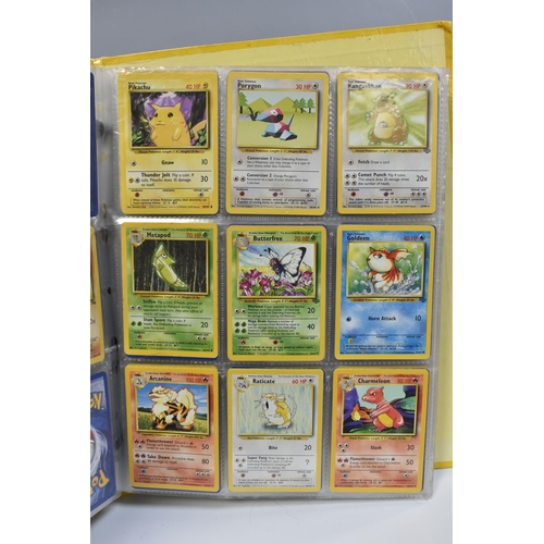 931 - A FOLDER OF POKEMON CARDS, includes cards from the Base Set, Base Set 2, Jungle, Fossil, Team Rocket... 