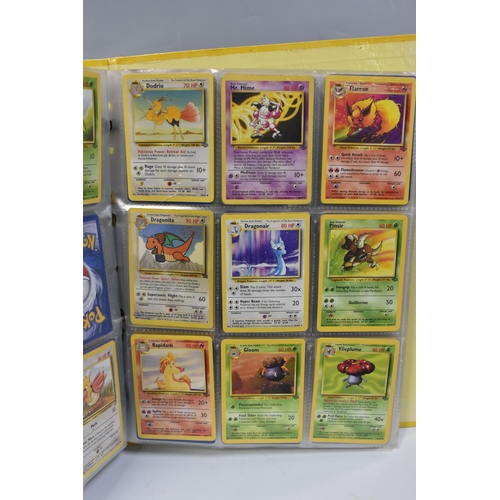 931 - A FOLDER OF POKEMON CARDS, includes cards from the Base Set, Base Set 2, Jungle, Fossil, Team Rocket... 