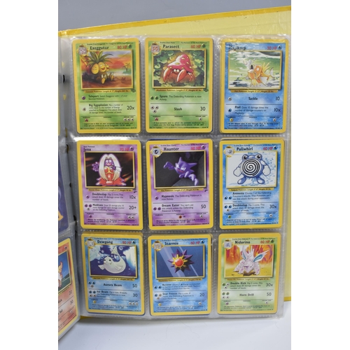 931 - A FOLDER OF POKEMON CARDS, includes cards from the Base Set, Base Set 2, Jungle, Fossil, Team Rocket... 