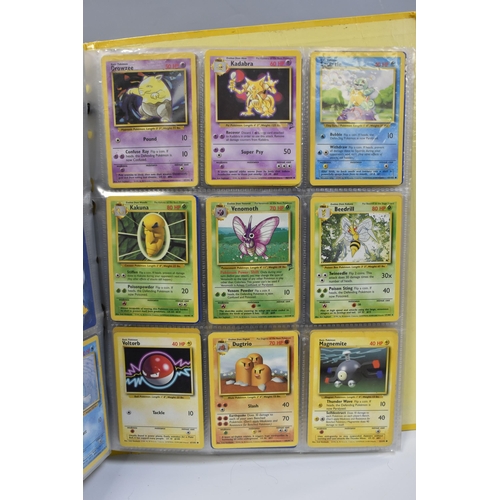 931 - A FOLDER OF POKEMON CARDS, includes cards from the Base Set, Base Set 2, Jungle, Fossil, Team Rocket... 