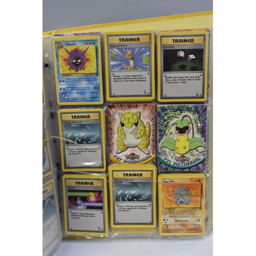 931 - A FOLDER OF POKEMON CARDS, includes cards from the Base Set, Base Set 2, Jungle, Fossil, Team Rocket... 