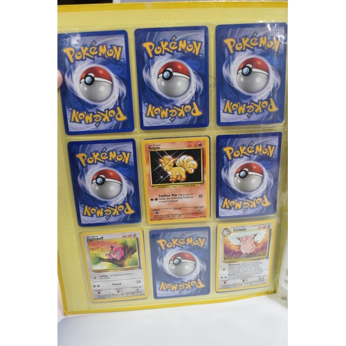 931 - A FOLDER OF POKEMON CARDS, includes cards from the Base Set, Base Set 2, Jungle, Fossil, Team Rocket... 