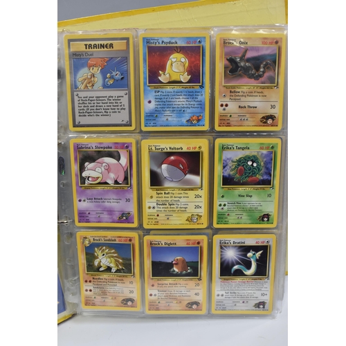 931 - A FOLDER OF POKEMON CARDS, includes cards from the Base Set, Base Set 2, Jungle, Fossil, Team Rocket... 