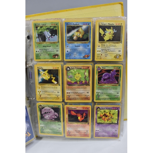 931 - A FOLDER OF POKEMON CARDS, includes cards from the Base Set, Base Set 2, Jungle, Fossil, Team Rocket... 