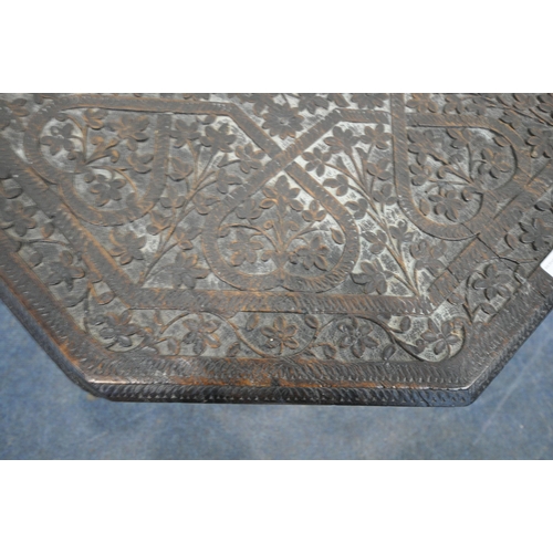 155 - A 20TH CENTURY EBONISED OAK OCTAGONAL ANGLO INDIAN TABLE, with intricate carved details all over, di... 