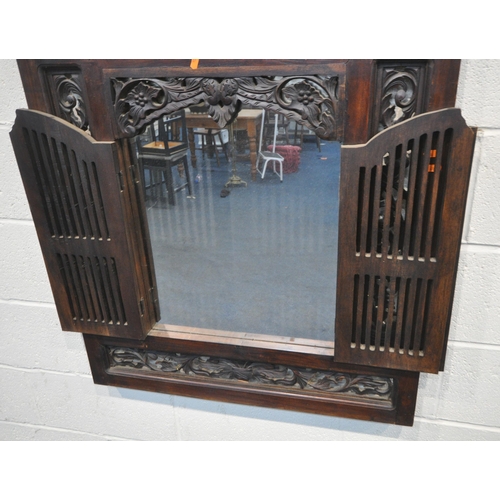 172 - A 20TH CENTURY HARDWOOD SHUTTER MIRROR, with foliate carved details, and double slatted doors, 81cm ... 