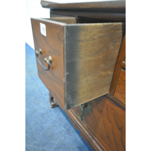 175 - A REPRODUCTION KOREAN ELM LOW CABINET, with a shaped top, brass mounts, six assorted drawers, over d... 