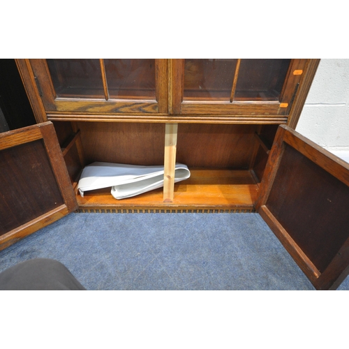 177 - A 20TH CENTURY OAK BOOKCASE, with double glazed doors, over smaller cupboard doors, width 92cm x dep... 