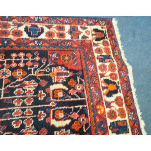 181 - AN IRANIAN WOOLEN RUG, with repeating geometric patterns, surrounded by a multi-strap border, 260cm ... 