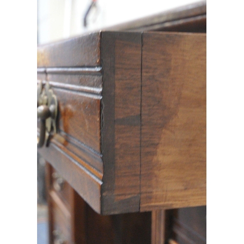 189 - A 20TH CENTURY WALNUT KNEEHOLE DESK, with a green writing surface, fitted with nine assorted drawers... 