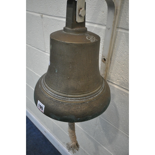 190 - A GEORGE VI BRASS BELL, engraved G R VI, with a hanging striker and rope handle, attached to a white... 