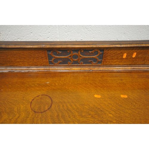 192 - A 20TH CENTURY OAK SIDEBOARD, with a raised back, fitted with double cupboard doors, a scrolled apro... 