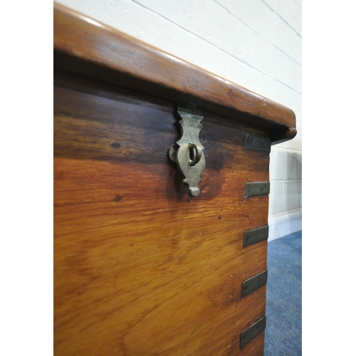 196 - A LATE 20TH CENTURY HARDWOOD BLANKET CHEST, with twin handles, brass banding, the hinged lid enclosi... 