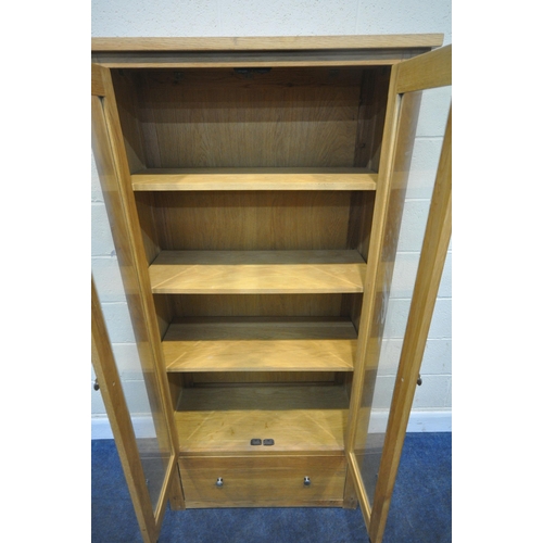 201 - A MODERN OAK DISPLAY CABINET, with double glass doors, over a single deep drawer, width 81cm x depth... 