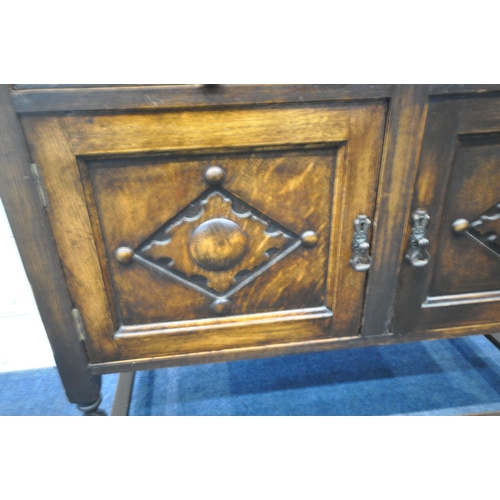 218 - A 20TH CENTURY OAK DRESSER, the two tier plate rack, atop a base with two drawers, over double cupbo... 