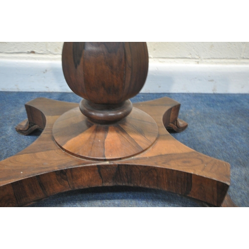 225 - A REGENCY ROSEWOOD TABLE, with a later rotating top, octagonal tapered base, raised on a shaped base... 