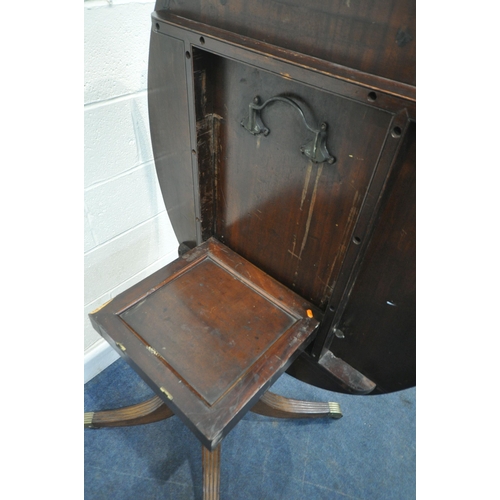 229 - A 20TH CENTURY MAHOGANY OVAL TILT TOP TABLE, raised on a turned support and four legs, width 136cm x... 