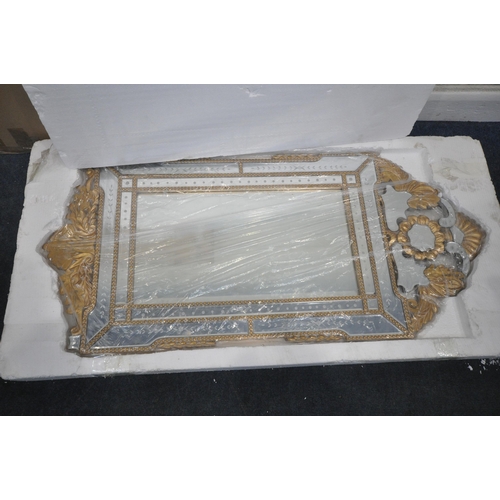 231 - A NEW IN BOX VENETIAN WALL MIRROR, with a foliate gilt frame, 65cm x 140cm, condition report: new in... 