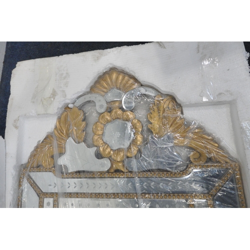 231 - A NEW IN BOX VENETIAN WALL MIRROR, with a foliate gilt frame, 65cm x 140cm, condition report: new in... 