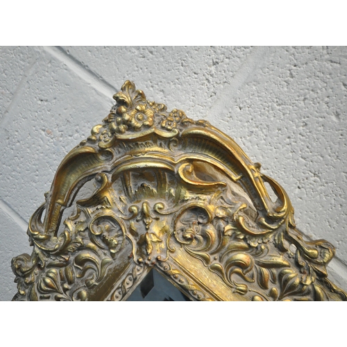 239 - PEERART WORKS COLNE LANCASHIRE ENGLAND, A GILT FRAME BEVELLED EDGE WALL MIRROR, with intricate detai... 