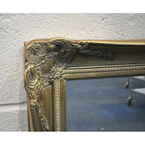 240 - A GILT FRAME RECTANGULAR BEVELLED EDGE WALL MIRROR, with scrolled and foliate details, 105cm x 74cm,... 