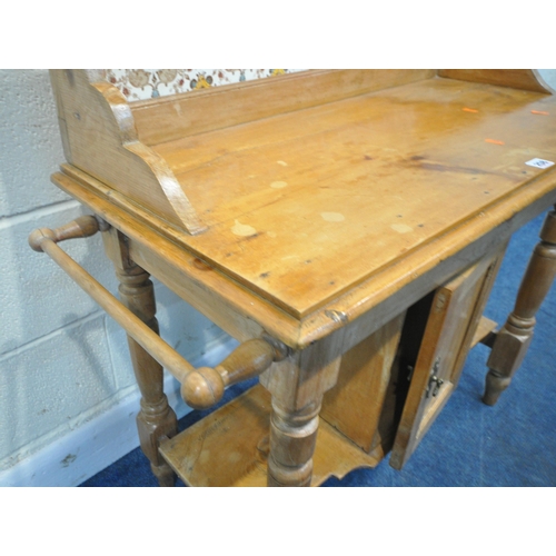 258 - A 19TH CENTURY PINE WASHSTAND, the raised back with tile inserts, a rail to each end, a single cupbo... 