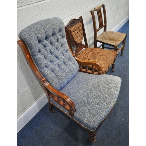 274 - AN EARLY 20TH CENTURY ARMCHAIR, with blue buttoned upholstery, raised on turned front legs, with cas... 