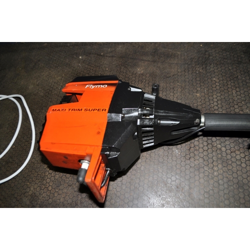 52 - A FLYMO MAXI TRIM SUPER PETROL STRIMMER with shoulder strap (engine pulls freely but hasn't started)