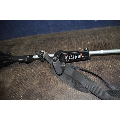 52 - A FLYMO MAXI TRIM SUPER PETROL STRIMMER with shoulder strap (engine pulls freely but hasn't started)