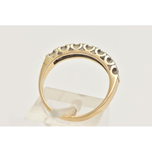 403 - A 9CT GOLD DIAMOND HALF ETERNITY RING, set with a row of seven small round brilliant cut diamonds, e... 