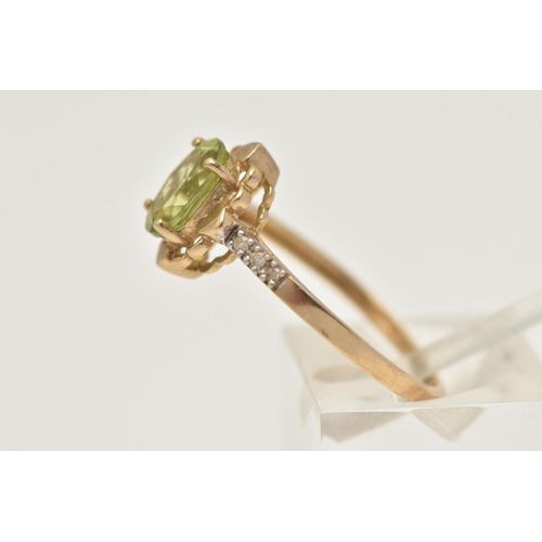 404 - A 9CT GOLD GEM SET RING, set with an oval cut peridot in a four claw scalloped surround, to the sing... 