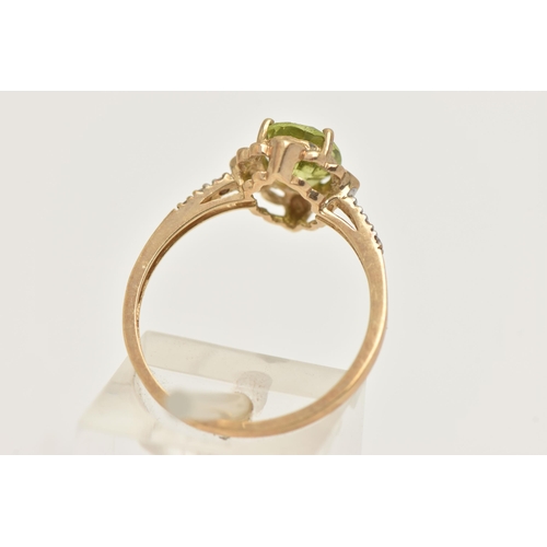 404 - A 9CT GOLD GEM SET RING, set with an oval cut peridot in a four claw scalloped surround, to the sing... 