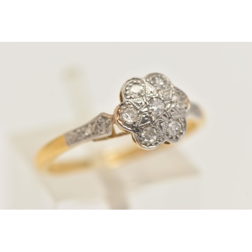 405 - A YELLOW METAL DIAMOND DAISY RING, flower head set with seven small single cut diamonds, with single... 