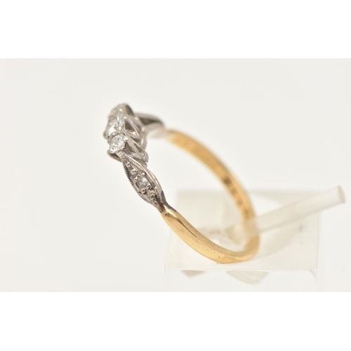 406 - A YELLOW METAL DIAMOND THREE STONE RING, designed as a central round brilliant cut diamond, flanked ... 