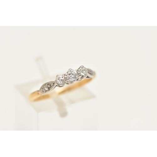 406 - A YELLOW METAL DIAMOND THREE STONE RING, designed as a central round brilliant cut diamond, flanked ... 