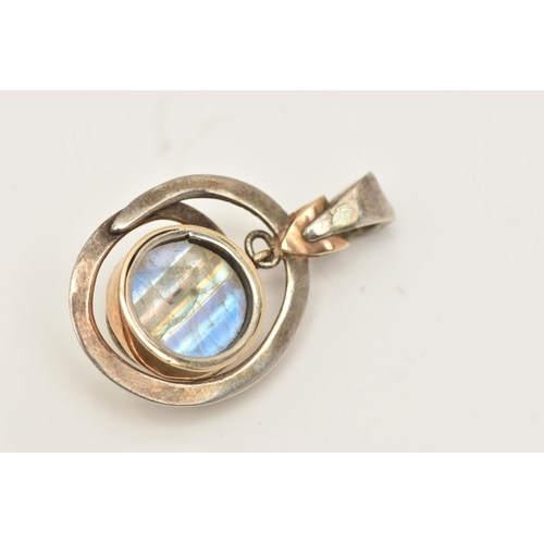 415 - A WHITE  METAL MOONSTONE PENDANT, set with a circular moonstone cabochon, collet set within a yellow... 