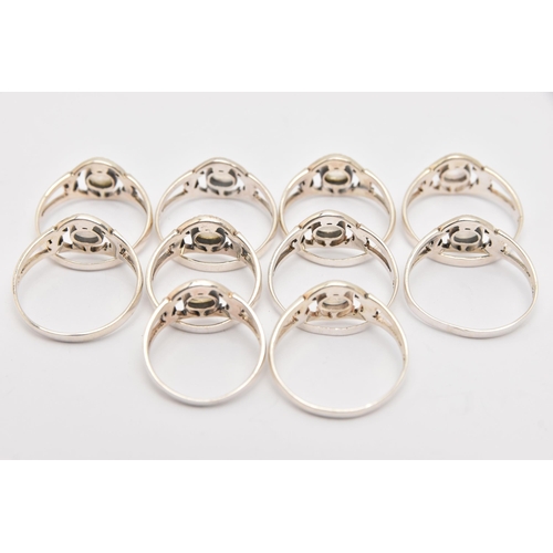 447 - TEN WHITE METAL MOONSTONE THISTLE RINGS, all of the same design, each stamped 925, various ring size... 