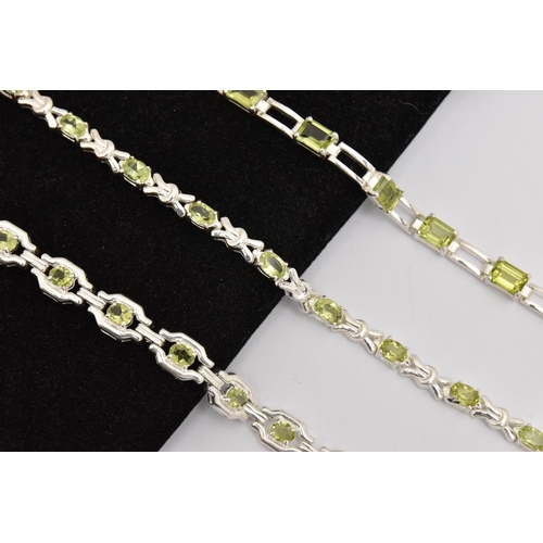 449 - THREE WHITE METAL GEM SET LINE BRACELETS, different designs, all set with peridots, fitted with inte... 