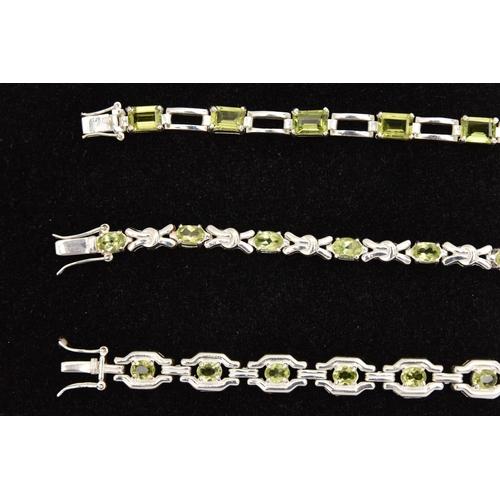 449 - THREE WHITE METAL GEM SET LINE BRACELETS, different designs, all set with peridots, fitted with inte... 