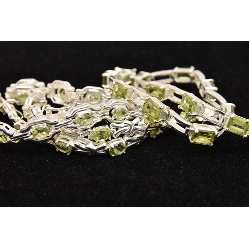 449 - THREE WHITE METAL GEM SET LINE BRACELETS, different designs, all set with peridots, fitted with inte... 